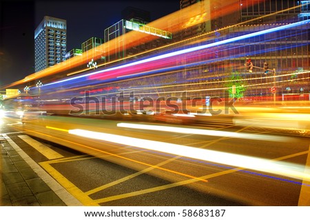 High speed and blurred bus light trails in downtown night-scape