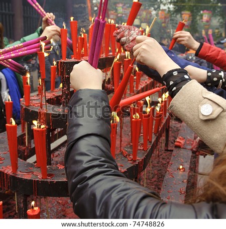 People burning incense upon the incense altar in temple during chinese new year.Many people want to relieve their worries and difficulties by burning incense during festivals.