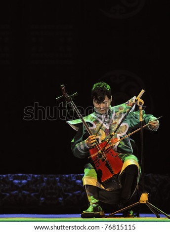 CHENGDU, CHINA - SEPT. 28: Mongolian ethnic musician performs on stage in the 6th Sichuan minority nationality culture festival at JINJIANG theater on Sept. 28, 2010 in Chengdu, China.