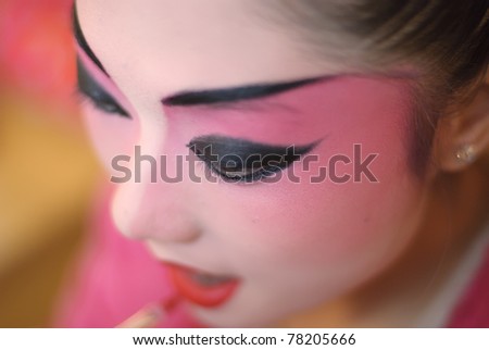 CHENGDU, CHINA - DEC 15: An unidentified Chinese opera actress paints her face while backstage at JingJiang theater on Dec 15, 2007 in Chengdu, China.