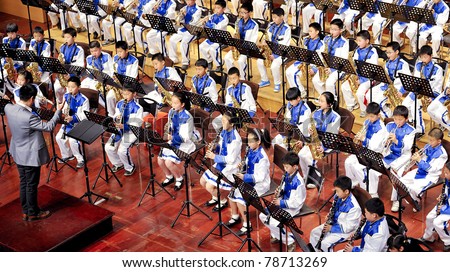 CHENGDU, CHINA - APRIL 23: The student symphonic band of High School No.7 Chengdu performs a concert on April 23, 2011 in Chengdu, China.