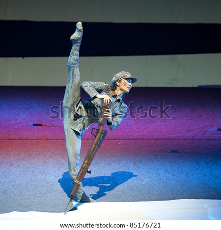 CHENGDU, CHINA - MAY 25: A member of the  Chinese Modern Dance Drama Red Army\'s flower performs on stage at Xinan theater on May 25, 2011 in Chengdu, China.