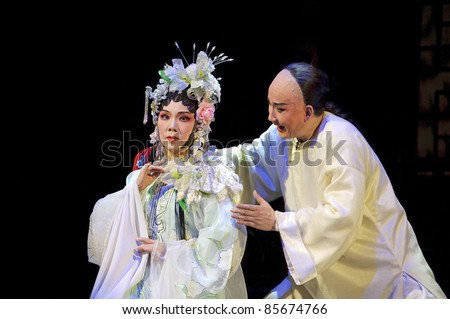 CHENGDU - JUN 3: Chinese Cantonese opera performer make a show on stage to compete for awards in 25th Chinese Drama Plum Blossom Award competition at Jinsha theater.Jun 3, 2011 in Chengdu, China.
