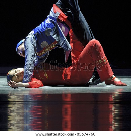 CHENGDU - DEC 9: Modern dancers perform duo dance on stage at JINCHENG theater in the 7th national dance competition of china.Dec 9,2007 in Chengdu, China.