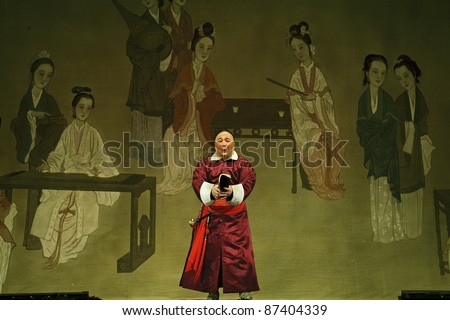 CHENGDU - JUN 3: chinese Cantonese opera performer make a show on stage to compete for awards in 25th Chinese Drama Plum Blossom Award competition at Jinsha theater.Jun 3, 2011 in Chengdu, China.