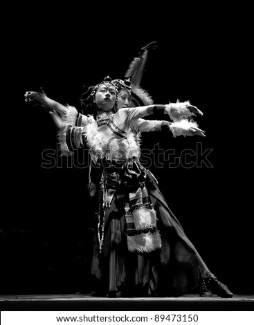 CHENGDU, CHINA - SEPT 28: Chinese Tibetan ethnic dancers perform on stage in the 6th Sichuan minority nationality culture festival at JINJIANG theater on Sept. 28, 2010 in Chengdu, China.