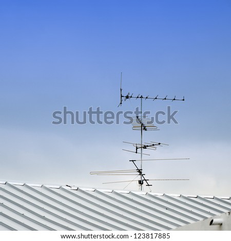 TV antenna on top roof with raining cloud