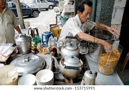 BANGKOK, THAILAND - October 28 : Unidentified man prepares bean curd jelly dessert for sell on October 28, 2012 in Bangkok, Thailand.