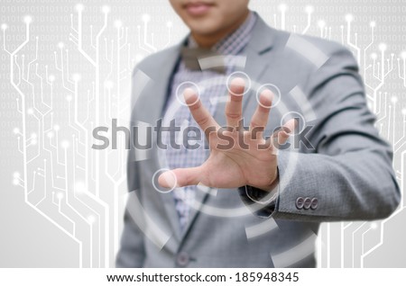 Businessman blocking or protecting computer data.