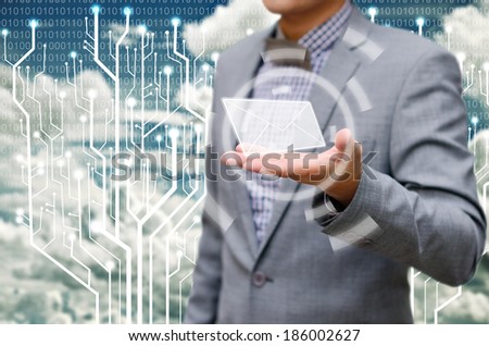 Contact us concept, businessman receiving mail from the cloud.