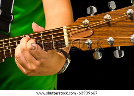 Hand and guitar play the music