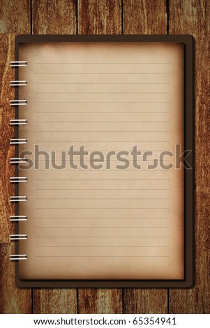 Old notebook on wooden table