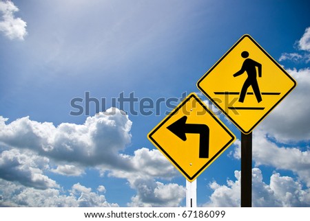 Turn left sign and a man walking sign with cloudy sky
