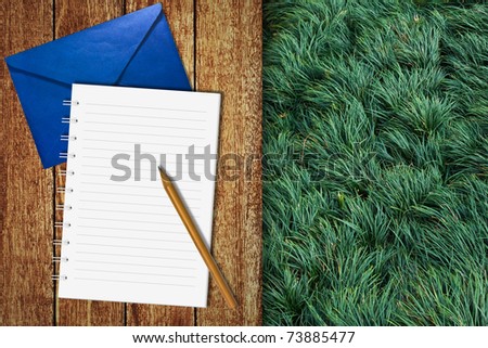 Write letter on wooden floor with green grass background