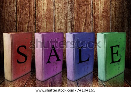 Book with sale event on wooden shelf