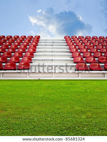 Red bleachers with green field background