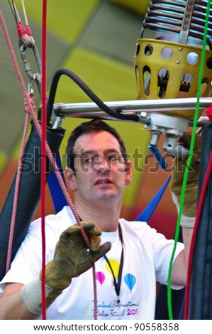 CHIANG MAI, THAILAND - NOV 25 : Unidentified man to prepare the faucet of gas in Hot air balloon on Nov 25, 2011 at Prince Royal\'s College in Chiang Ma, Thailand International Balloon Festival 2011