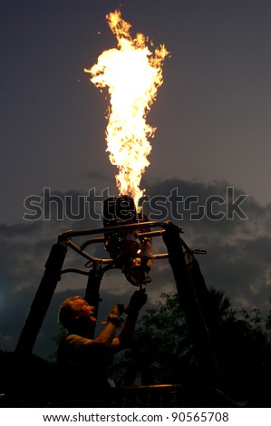 CHIANG MAI - NOV 26: Unidentified pilot testing burner of Hot air balloon during Thailand balloon festival 2011 at Prince Royal college in Chiang mai, Thailand on Nov 26, 2011.