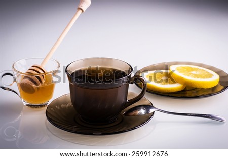 Cup of tea with lemon slices and honey