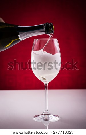 Pouring sparkling wine in a glass; preparing spritz; wine-based long drink, slightly alcoholic.
