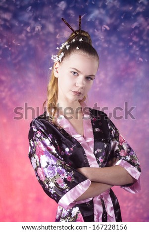 portrait of young teenage girl in floral kimono in studio
