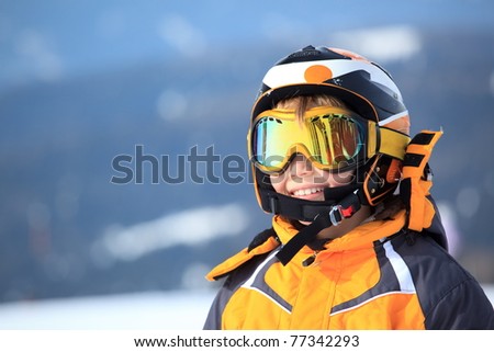 A young boy skier in his snow gear.