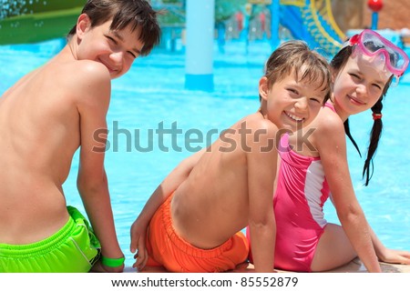 Happy siblings by pool