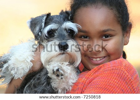 Little girl and her miniature schnauzer puppy.