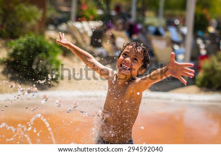 Young boy playing in the water at a water park in California