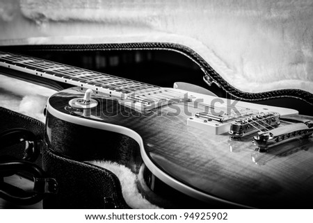 Black and White of Beautiful Electric Guitar Laying in a Hard Shell Guitar Case