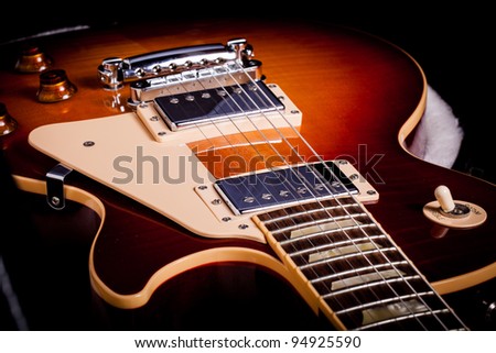 Close up of a Two Tone Electric Guitar laying in a Hard shell Guitar Case