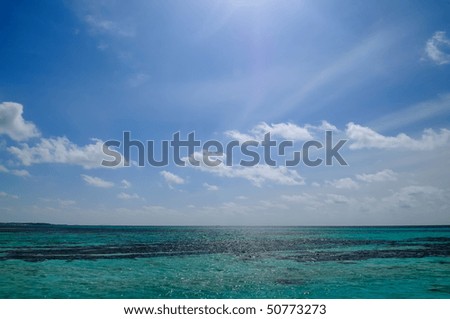 On one day at the end of rainy season in Maldives, a beautiful cloudscape on a blue sky over a fresh blue sea was captured.