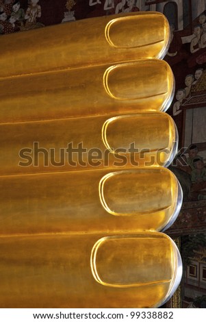 The golden toes of Buddha, foot detail of reclining Buddha-statue inside of Buddhist temple Wat Po, Bangkok, Thailand