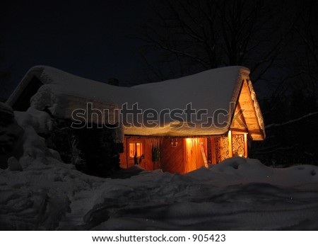mountain house in the snow at night