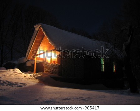 alpine hut in the snow at night