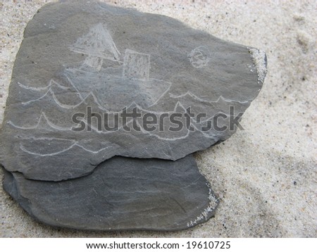 painting ship boat and waves on the stone on the sand at the beach