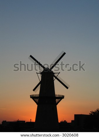 Windmill at the sunset. This is the tallest classic windmill in the world. The windmill is placed at the center of the picture.
