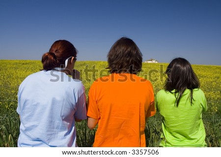 Friends with colorful tshirts watching the landscape full of yellow daisies