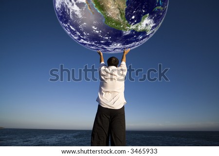 Man with white shirt holding the planet earth - science and environment concept