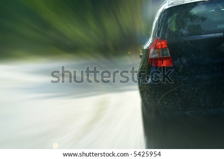 Black sports car speeding in highway