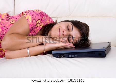 young woman sleeping over laptop computer