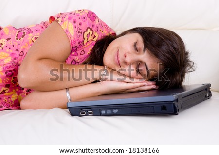 young woman sleeping with head over laptop computer