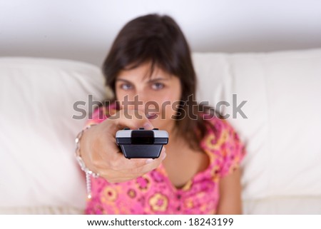 young woman holding television remote control