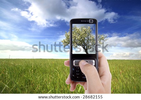woman taking photo with mobile cell phone - landscape orientation
