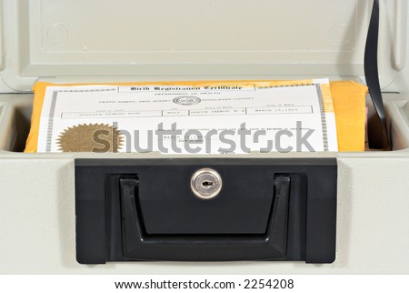 An open fire proof security box with a birth certificate inside