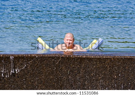 A adult man cooling off in a lake