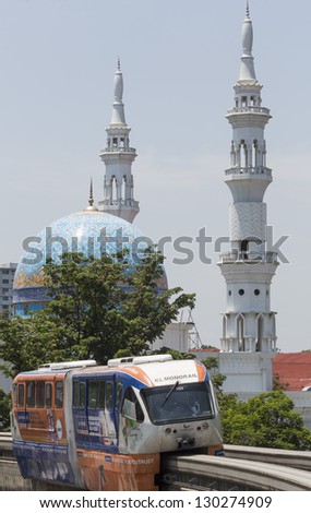 KUALA LUMPUR-MARCH 4: The KL Monorail train moving past an Islamic mosque on March 4, 2013 in Kuala Lumpur, Malaysia. Malaysia is a multi-ethnic country with Islam being the largest practiced religion