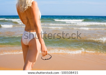 Girl with a slender figure in the background of the sea