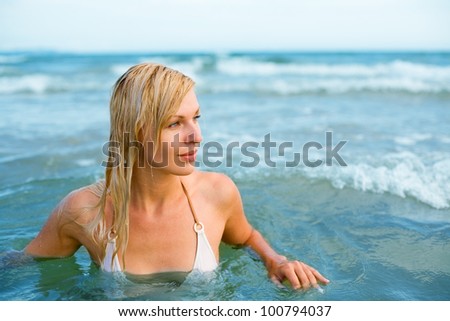 Beautiful young woman floating in the sea