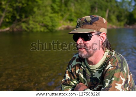 Attractive middle aged man at the river vacation.
